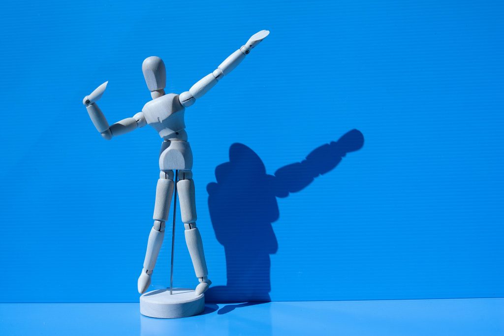 Wooden Figurine against a Blue Background